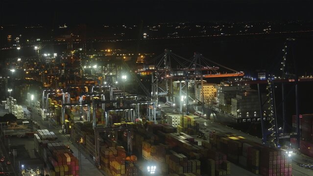 Rio de Janeiro, Brazil - 17 June 2026: Aerial view of Porto do Rio de Janeiro at night, with illuminated container terminals, gantry cranes, and stacks of shipping containers.