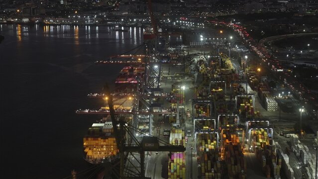 Rio de Janeiro, Brazil - 17 June 2026: Aerial view of Porto do Rio de Janeiro at night, with rows of colorful shipping containers, towering cranes, and illuminated port infrastructure.