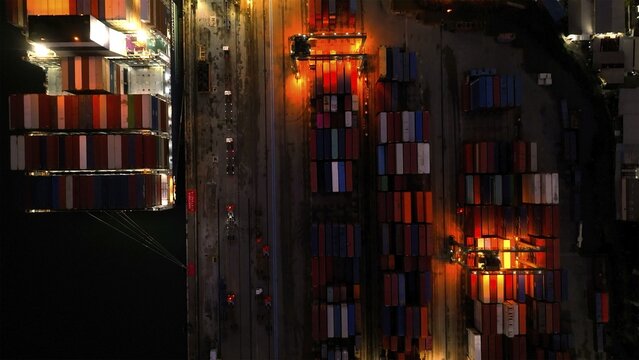 Rio de Janeiro, Brazil - 17 June 2026: Aerial view of Porto do Rio de Janeiro with colorful shipping containers stacked in the port terminal at night under artificial lighting.