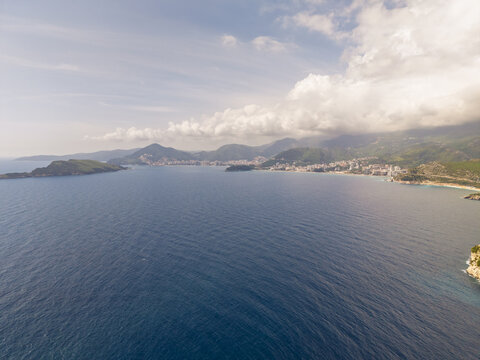 Aerial view of the Adriatic coastline near the historic islet of Sveti Stefan with mountains and blue sea in Sveti Stefan, Budva Municipality, Montenegro.