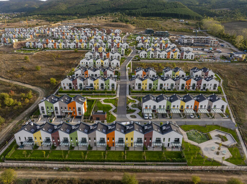 Aerial view of Residential Park Lozen featuring modern colorful townhouses with green lawns and paved walkways in Sofia, Sofia City Province, Bulgaria.