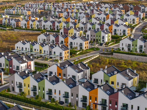 Aerial view of Residential Park Lozen featuring modern colorful houses with pitched roofs and orderly streets in Sofia, Sofia City Province, Bulgaria.