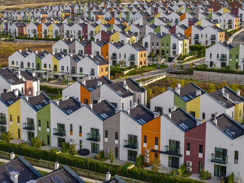 Aerial view of the Residential Park Lozen EOOD housing complex, featuring rows of colorful modern townhouses with pitched roofs in Sofia, Sofia City Province, Bulgaria.