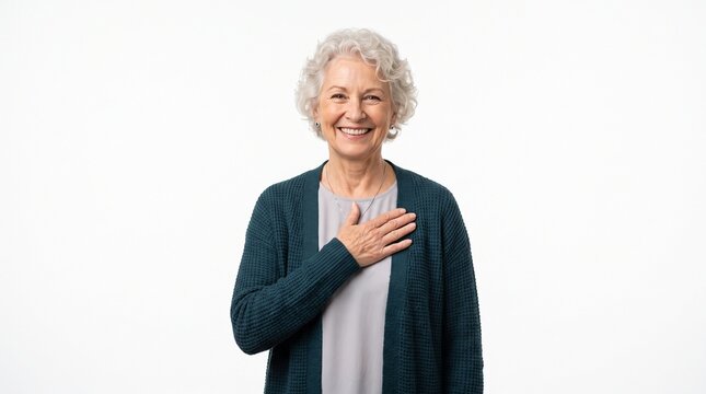 Smiling senior woman with hand on heart expressing gratitude and sincerity