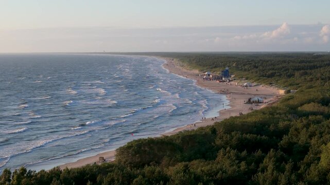 Aerial view of the sandy Palanga beach coastline bordered by dense pine forests and the Baltic Sea in Palanga, Klaipeda County, Lithuania.