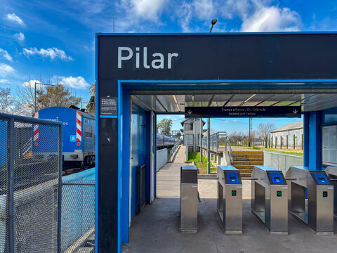 Entrance turnstiles and main sign at Pilar railway station - Argentina