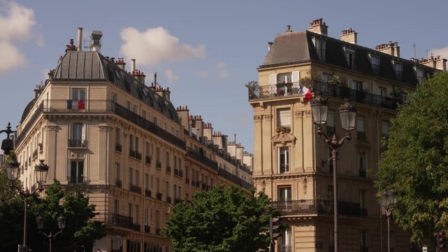 French flag on a corner building above a Paris street
