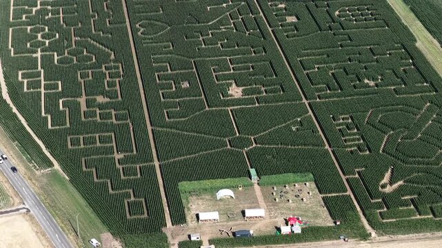Aerial view of a large intricate corn maze with paths and patterns surrounded by agricultural fields in Soultz-Haut-Rhin, Grand Est, France.