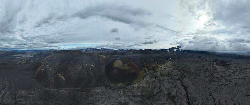 Aerial view of the volcanic Raudaskal crater, dark lava fields, and mossy slopes in the landscape of Akureyri, Rangarthing ytra, Iceland.