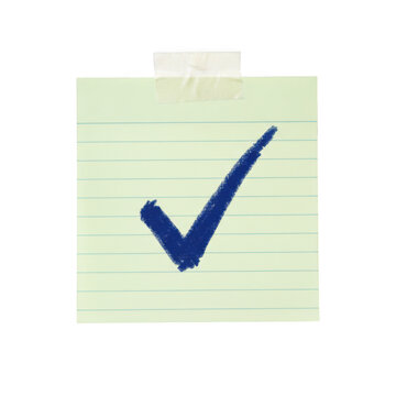 Light green sticky note with a dark blue hand drawn check mark symbol taped to a surface