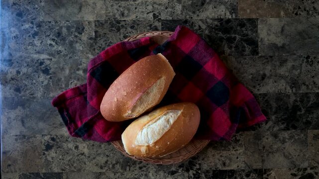 Serving fresh mexican bolillo bread for breakfast on a marble counter