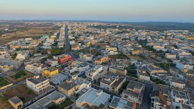 Aerial view of the historic town of Giuliano Di Lecce with traditional stone buildings, narrow streets, and surrounding rural landscape in Puglia. Giuliano Di Lecce, Puglia, Italy.