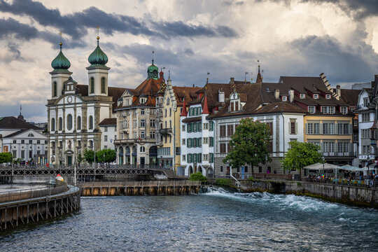 View of the historic Jesuit Church with its distinctive twin onion domes, situated along the Reuss River in the old town of Lucerne, Lucerne, Switzerland.