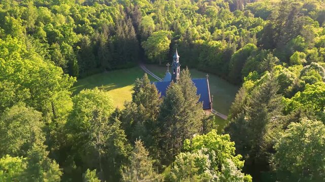 Aerial view of the Schwarzenberg Tomb nestled in the lush green forest park of Orlik nad Vltavou, Kozli, Jihocesky kraj, Czechia.