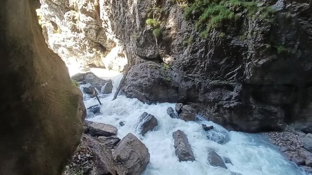 Powerful mountain river rushing through a deep rocky gorge in the Bavarian Alps