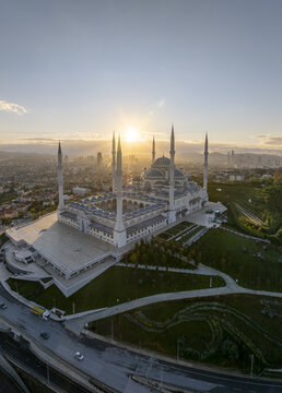 Aerial view of Grand Camlica Mosque with its six minarets and large central dome at sunset, overlooking the cityscape of Uskudar, Istanbul, Turkey.