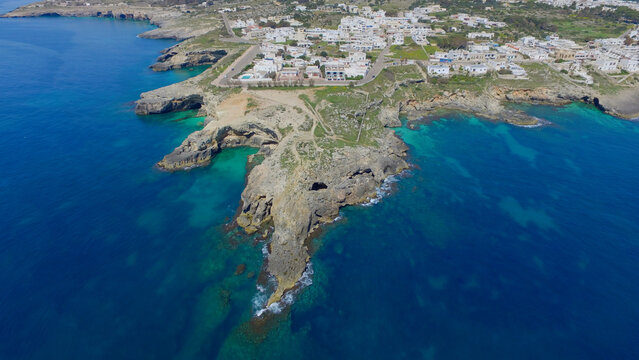 Aerial view of the rocky coastline and turquoise waters of Santa Maria di Leuca, Puglia, Italy.