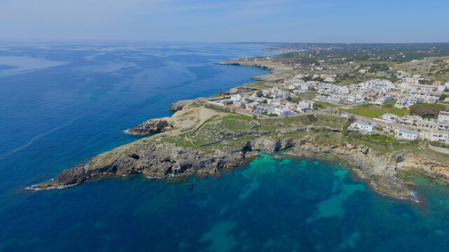 Aerial view of the rocky coastline and turquoise waters of Santa Maria di Leuca, Puglia, Italy.