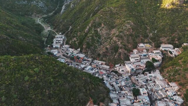 Aerial View of Saidpur VIllage covered in Margalla Hills Village with Cemetery at Golden Hour Pakistan