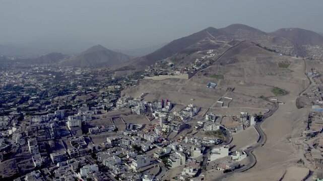 Aerial view of the wall separating the districts of San Juan de Miraflores and Santiago de Surco in the arid landscape of Lima Province, Lima Province, Peru.