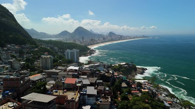 Aerial view of the hillside favelas overlooking the coastline and blue ocean in Rio de Janeiro, Rio de Janeiro, Brazil.