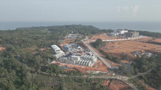 Aerial view of the Data Center Nongsa construction site surrounded by lush greenery and coastal landscape in Batam, Riau Islands, Indonesia.