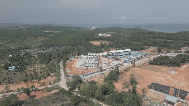 Aerial view of Data Center Nongsa Batam under construction surrounded by lush greenery and coastal landscape in Batam, Riau Islands, Indonesia.