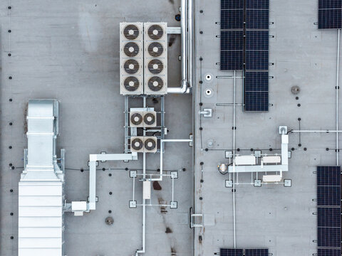 Aerial view of CH Targowek rooftop featuring HVAC ventilation units and solar panels in Warsaw, Masovian Voivodeship, Poland.