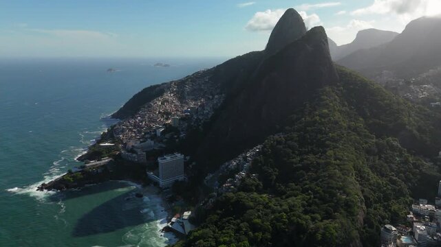 Aerial view of the iconic Morro Dois Irmaos mountain rising above the Vidigal neighborhood and the Atlantic coastline in Rio de Janeiro, State of Rio de Janeiro, Brazil.