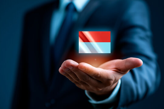 Businessman holding glowing digital Indonesia flag hologram over extended hand