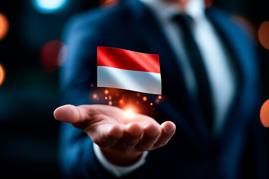 Businessman holding glowing digital Indonesia flag hologram over extended hand
