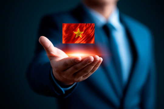 Businessman holding glowing digital Vietnam flag hologram over extended hand