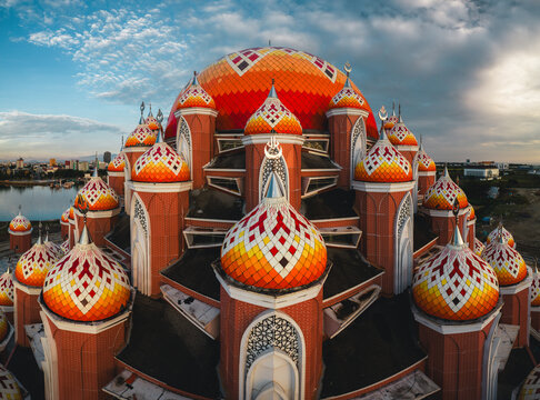 Aerial view of Masjid Kubah 99 Asmaul Husna with its distinctive colorful domes and intricate brick architecture in Makassar, Sulawesi Selatan, Indonesia.