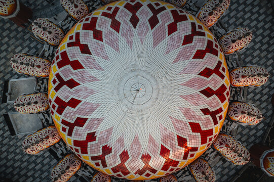 Aerial view of the colorful geometric dome of Masjid Kubah 99 Asmaul Husna in Kecamatan Mariso, Sulawesi Selatan, Indonesia.