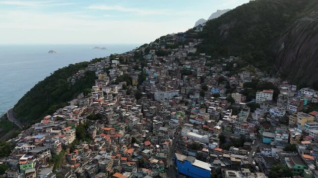 Aerial view of densely packed hillside favela houses overlooking the Atlantic Ocean in Rio de Janeiro, State of Rio de Janeiro, Brazil.