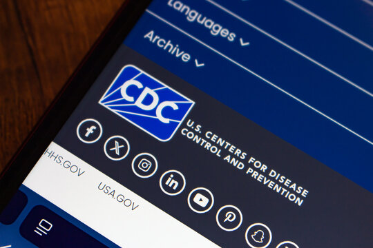 Mexico City, MEXICO - Jul 21 2026 : Angled close-up of a smartphone on a wooden surface showing the CDC logo and the name U.S. Centers for Disease Control and Prevention in the footer of the agency we