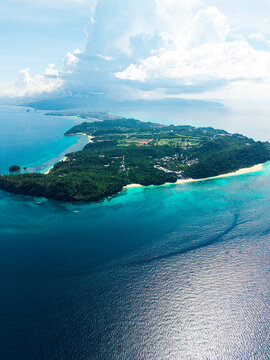 Aerial view of Boracay island, showing the northern side with lush green vegetation, white sand beaches, and turquoise waters in Malay, Western Visayas, Philippines.