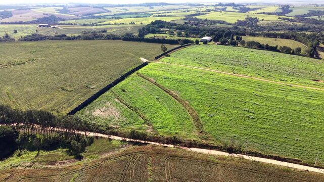 Aerial view of agricultural fields and farmland in a sunny day