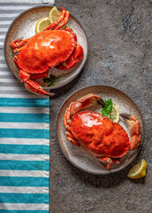 Whole cooked  crabs on white plate with lemon and beer. Top view © lblinova