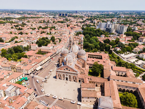 Aerial view of The Basilica of St. Anthony surrounded by historic terracotta rooftops and urban streets in Padua, Veneto, Italy.