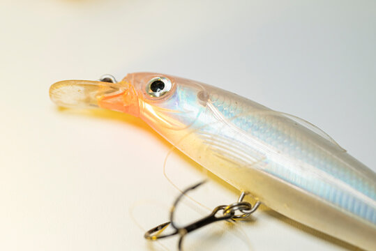 Iridescent wobbler bait for predator fish on a neutral background The Concept of design and outdoor activity