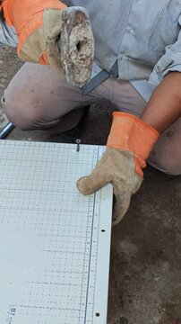 Person Securing Wooden Table Base Using Self Tapping Screw