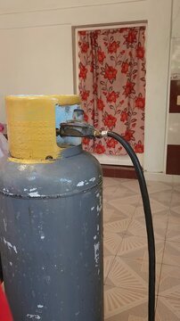 Applying Soapy Water Solution onto Propane Tank Valve to Check for Gas Leak
