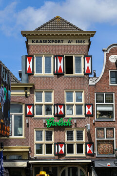 Historic Dutch Building with Grolsch Sign and "KAASEXPORT A&deg; 1885" Inscription in Alkmaar, Netherlands
