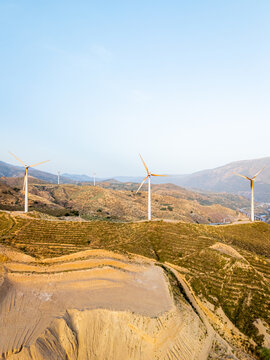 Aerial view of wind turbines situated on arid hills in Velez de Benaudalla, Andalusia, Spain.