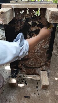 Restoring Rusted Metal Sheet Base with Protective Black Paint