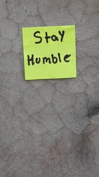 Motivational Sticky Note Reading Stay Humble Stuck on Concrete Wall
