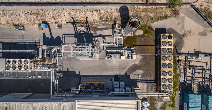 Romans-sur-Isere, France - 04 July 2026: Aerial view of the Veolia Onyx landfill gas recovery and treatment system, featuring a gas flare, cooling units, and pipe networks at an industrial facility.