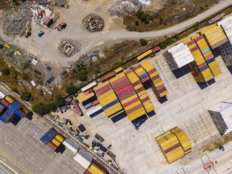Aerial view of colorful shipping containers stacked in rows at the port terminal in Sines, Setubal, Portugal.