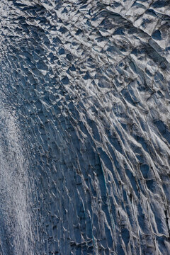 Aerial view of the intricate, deep blue crevasses and textured ice formations of the Skaftafellsjokull glacier surface in Vik, Myrdalshreppur, Iceland.